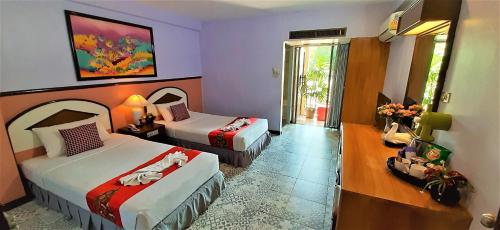 a hotel room with two beds and a window at D2 lamoon resotel in Phuket