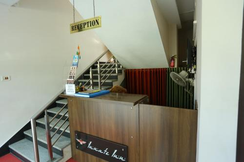 a stairway leading up to a staircase with a stair case at Hotel Innate Inn in Alwaye