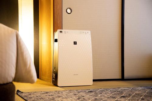 a refrigerator sitting on the floor next to a door at Kona Stay Bicycle Resort in Izunokuni