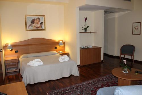 a hotel room with a bed with towels on it at Hotel Il Duca d'Este in Ferrara