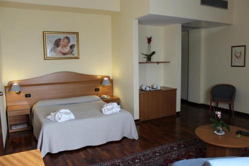 a hotel room with a bed with towels on it at Hotel Il Duca d'Este in Ferrara