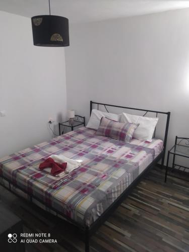 a bedroom with a bed with a blanket on it at Simbas House in Leonidion