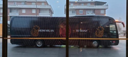 a black bus is parked in a parking lot at Hotel Il Duca d'Este in Ferrara