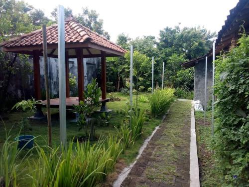 a gazebo in the middle of a garden at Pendopo Kayuwanan Syariah Near Terminal Giwangan in Yogyakarta