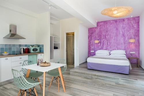 a kitchen and a bedroom with a bed and a table at Villa Nena - Studio Suites in Kalami