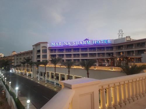 a building with a sign that reads marina sharjah hotel at Marina Sharm Hotel in Sharm El Sheikh