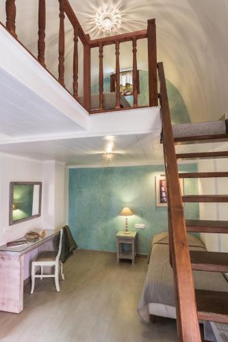 a bedroom with a bunk bed and a staircase at Hotel Sunrise in Fira