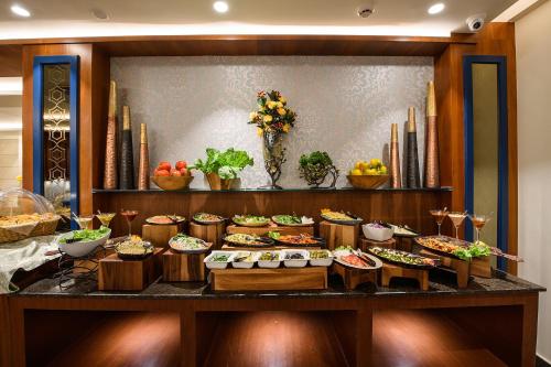 a buffet with many different types of food on a table at Best Western Plus Revanta Mcleod Ganj in Dharamshala