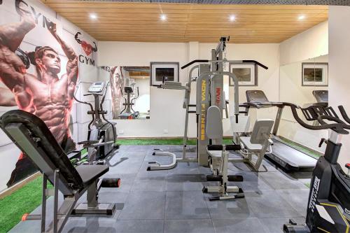 a gym with treadmills and machines in a room at Best Western Plus Revanta Mcleod Ganj in Dharamshala