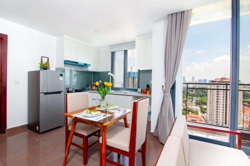 a kitchen and living room with a table and a kitchen with a view at MekongView 6 CondoTel in Phnom Penh