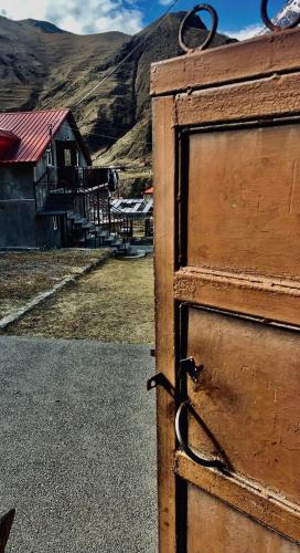 an old wooden door in front of a house at Guest house chavchavadze N23 in Stepantsminda