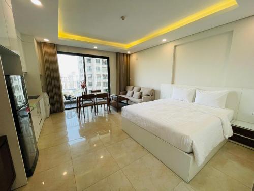 um quarto com uma grande cama branca e uma sala de estar em Gavi Home - Luxury Apartment D'Capitale Trần Duy Hưng Hà Nội em Hanói