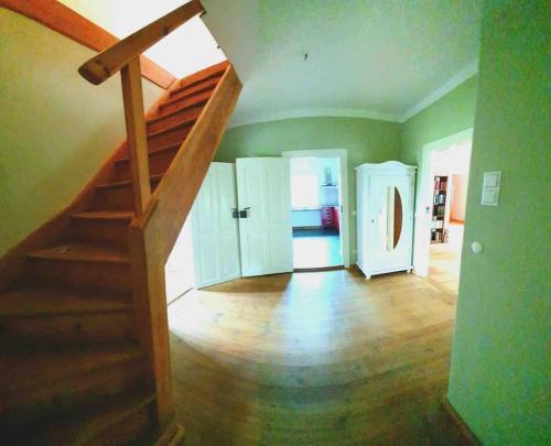 a living room with a staircase and a room with a staircase at Alexandrowka Wohnen im UNESCO Weltkulturerbe Haus in Potsdam