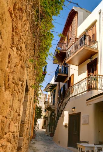 an alley in an old town with buildings at Palazzo Duca in Chania Town
