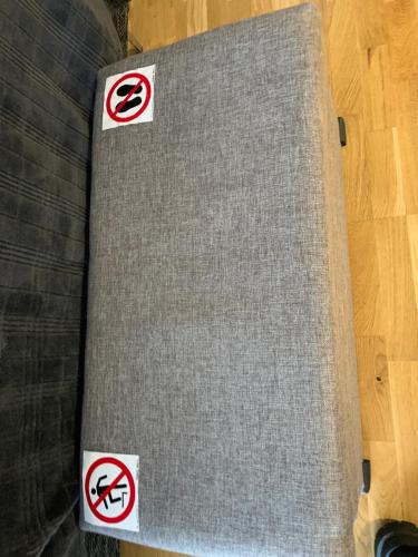 a table with signs on it on a wooden floor at Oja 118 Apartment in Pärnu