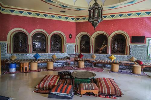 a room with red walls and tables and chairs at Regency Hotel & Spa in Monastir