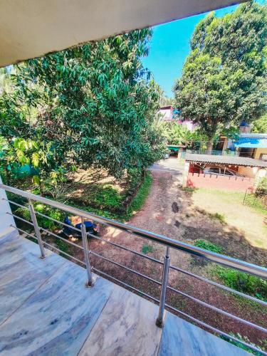 a view from a balcony with a fence and trees at Auslyn Guest House in Bogmolo