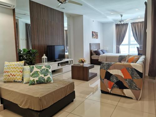 a living room with two beds and a couch and a tv at Mansion One by Sky Hive in George Town