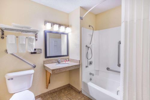 a bathroom with a toilet and a sink and a shower at Super 8 by Wyndham Decorah in Decorah