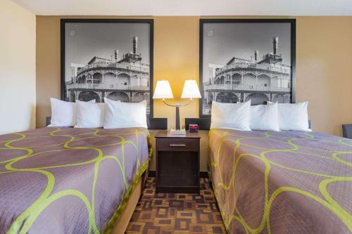 two beds sitting next to each other in a hotel room at Super 8 by Wyndham Decorah in Decorah