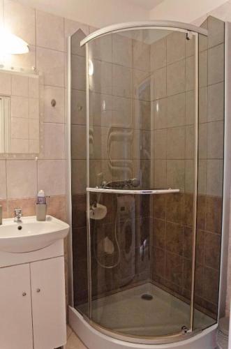 a shower with a glass door in a bathroom at Panorama View Apartment in Veszprém