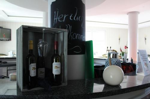a box of wine sitting on a counter in a kitchen at Hotel Residenz Bad Frankenhausen in Bad Frankenhausen