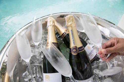 a bucket filled with champagne bottles and wine glasses at Tembo Beach Club & Resort in Bangrak Beach