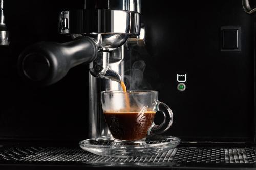 a coffee maker is making a cup of coffee at Harma Boutique Hotel in Hersonissos