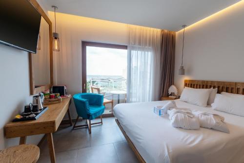 a hotel room with a bed and a desk and a computer at Harma Boutique Hotel in Hersonissos