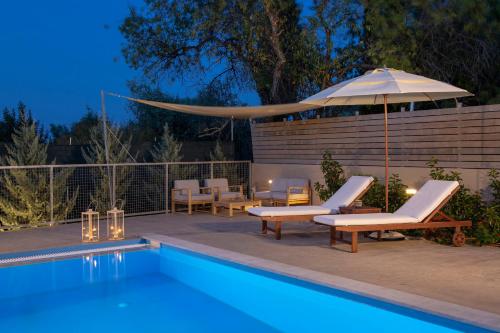 a swimming pool with chairs and an umbrella next to it at Grappolo Lefkada Villas - Villa Vertzami just 2 km from Lefkada town in Apolpaina