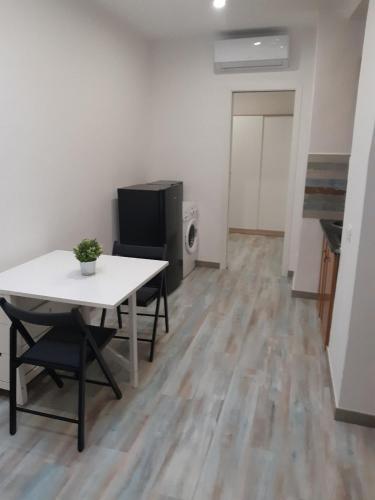 a living room with a table and a tv in a room at Guidonia Montecelio in Montecelio