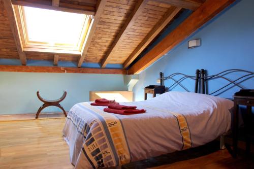 a bedroom with a bed with red towels on it at Casa Rural Ardantzena in Ardaiz