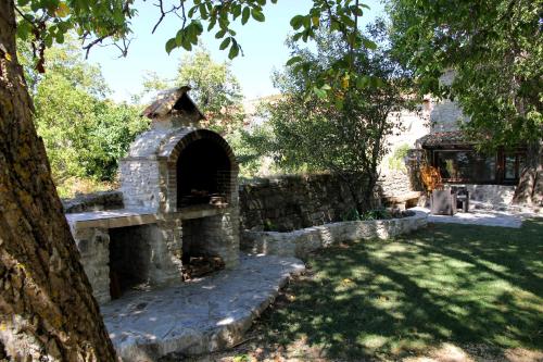 an outdoor brick oven in a yard with a tree at Casa Rural Ardantzena in Ardaiz