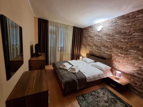 a bedroom with a brick wall and a bed at Borovets Sequoia2 Apartment no 5 in Borovets