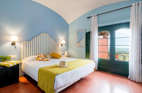 a bedroom with a large bed and a window at Mas Ses Vinyes - Adults Only in Begur