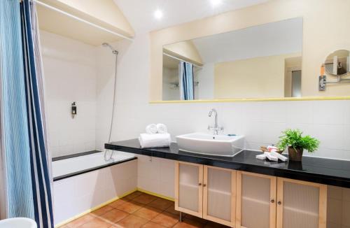 a bathroom with a sink and a mirror at Mas Ses Vinyes - Adults Only in Begur