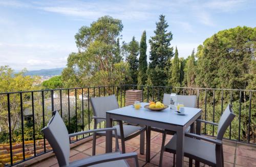 a patio with a table and chairs on a balcony at Mas Ses Vinyes - Adults Only in Begur