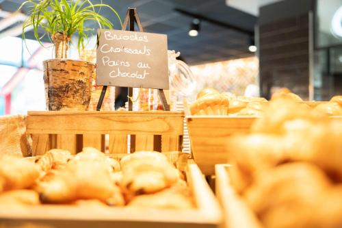 a display of pastries in a bakery with a sign at Novotel Valence Sud in Valence