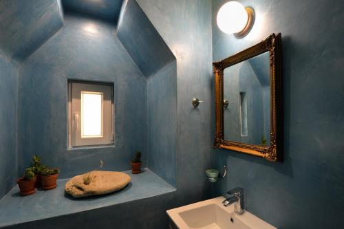 
a bathroom with a sink and a mirror at Locandiera in Corfu Town
