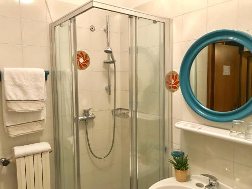 a bathroom with a shower, sink, and toilet at Garnì Hotel Tignale, GTSGroup in Tignale