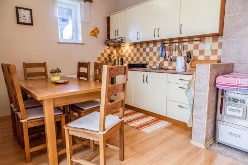 a kitchen with a wooden table and a dining room at Rodinný dom v Lučivnej pod Vysokými Tatrami in Lučivná