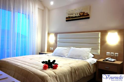 a bedroom with a bed with two teddy bears on it at Vournelis Beach Hotel and Spa in Iraklitsa