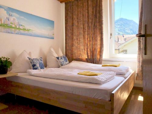 a bedroom with two beds and a window at Downtown Apartment 9 in Interlaken