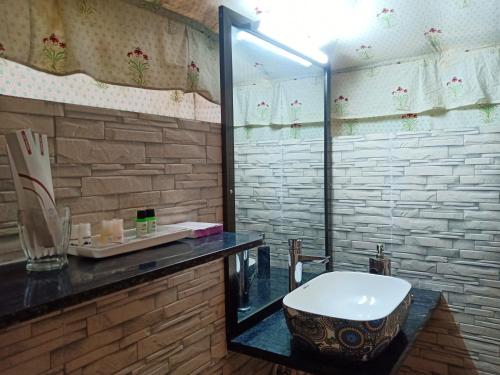 a bathroom with a glass shower and a toilet at Jawai Nature Stay - Leopard Safari Camp Jawai Bandh in Bīsalpur