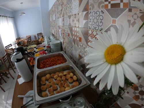 a table with a plate of food and a flower at Hotel e Pousada Magic in Penha