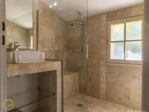 a bathroom with a shower and a sink at Les Garrigues de la Vallée des Baux in Paradou
