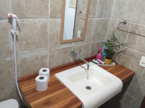 a bathroom with a sink and a toilet and a mirror at Sítio Maleleo in Porto De Galinhas