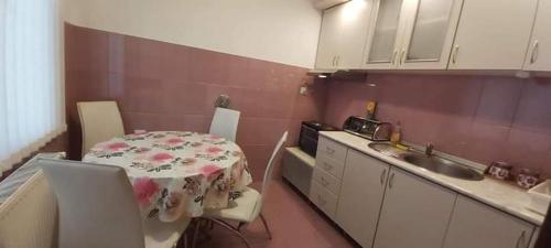 a small kitchen with a table and a sink at Apartman Ivanović 5 in Soko Banja