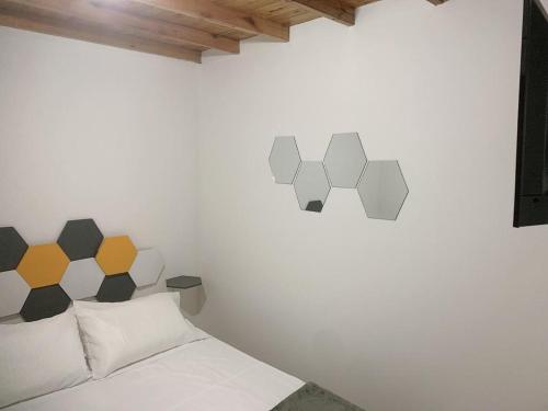a bedroom with a bed and a wall with geometric designs at JARDIN SECRETO in Jardin