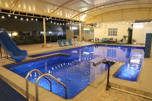 a large swimming pool with blue water at Aljood Resort in Ras al Khaimah
